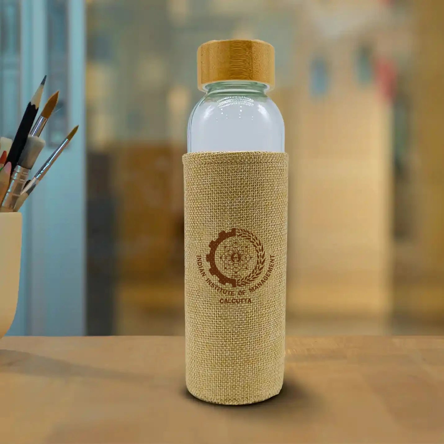 Eco-Friendly Transparent Bottle with Jute Sleeve – IIMC Edition